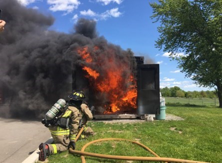Fire department putting out shed fire